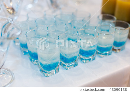 glowing drinks of the fluorescent bar, colorful cocktails with molecular caviar from blue syrups glowing drinks of the fluorescent bar, colorful cocktails with molecular caviar from blue syrups 48090188