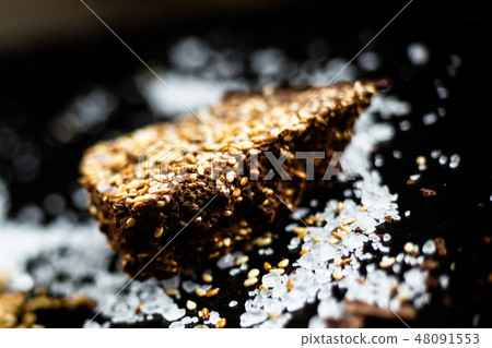 Luxury handmade dark chocolate with seasame and sea salt, black background Luxury handmade dark chocolate with seasame and sea salt, black background 48091553