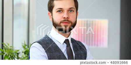 Handsome smiling bearded clerk man at workplace Handsome smiling bearded clerk man at workplace 48091666