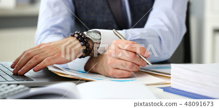 Clerk man at office workplace with silver pen Clerk man at office workplace with silver pen 48091673