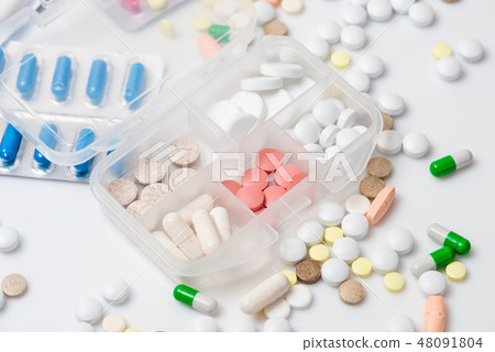 Close-up of pill case with various medications 48091804
