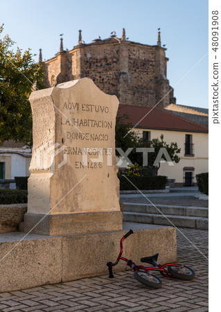 A child's bicycle thrown next to monolith that marks the house where Hernan Cortes was born A child's bicycle thrown next to monolith that marks the house where Hernan Cortes was born 48091908