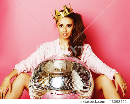 young cute disco girl on pink background with disco ball and crown young cute disco girl on pink background with disco ball and crown 48092531