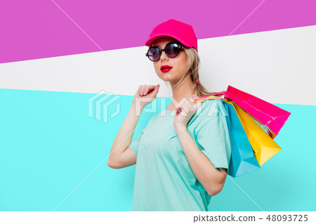 girl in blue t-shirt with shopping bags girl in blue t-shirt with shopping bags 48093725
