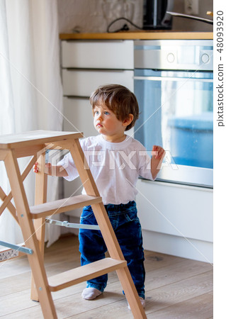 Little toddler boy stay at kitchen 48093920