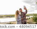 Young attractive couple taking selfie near the riv 48094517