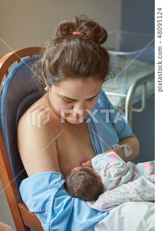 Young woman breastfeeding newborn baby 48095124