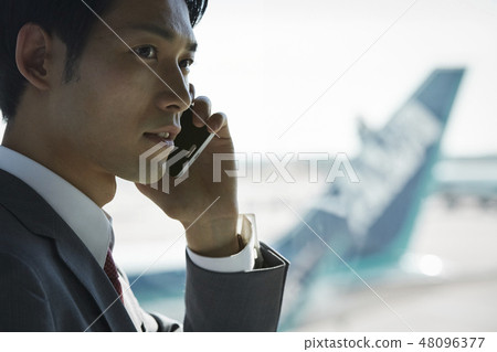 A businessman on a business trip abroad to call at the airport A businessman on a business trip abroad to call at the airport 48096377
