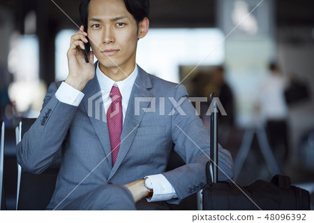 A businessman on a business trip abroad to call at the airport 48096392