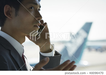 A businessman on a business trip abroad to call at the airport 48096470