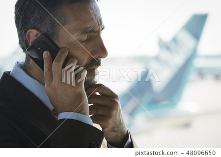 A businessman on a business trip abroad to call at the airport 48096650