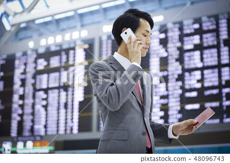 A businessman on a business trip abroad to call at the airport 48096743