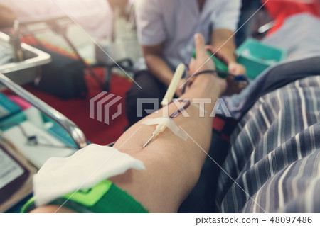 Nurse receiving blood from blood donor in hospital 48097486