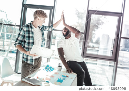Positive delighted colleagues celebrating their result 48098996