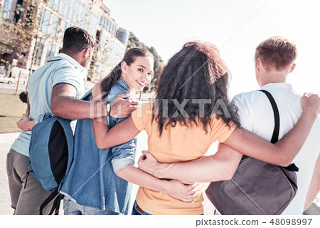 Attractive female person standing near her group mates Attractive female person standing near her group mates 48098997