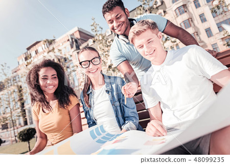 Delighted students thinking about new details 48099235