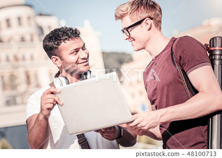 Cheerful blonde man standing in semi position Cheerful blonde man standing in semi position 48100713