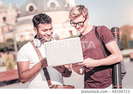 Attentive boys looking at screen of computer Attentive boys looking at screen of computer 48100723
