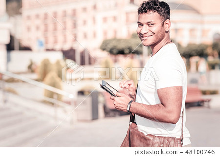 Positive delighted man looking at camera Positive delighted man looking at camera 48100746