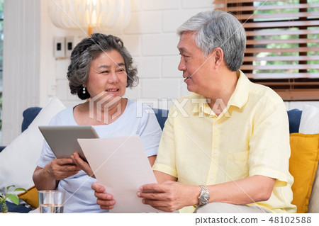 Asian senior couple use tablet retirement finance 48102588