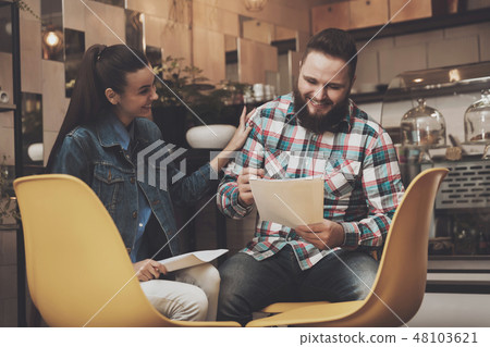 Young people studying documents while in a cafe 48103621