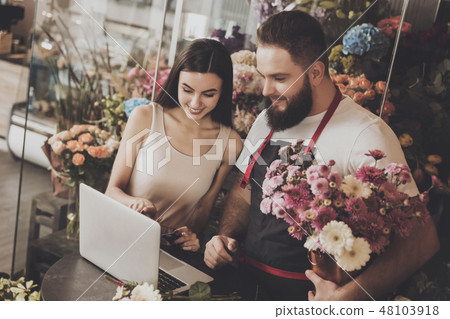 Young girl chooses bouquet option on laptop Young girl chooses bouquet option on laptop 48103918