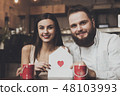 Young romantic woman holding envelope with heart 48103993