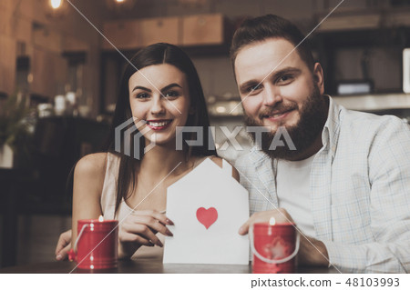 Young romantic woman holding envelope with heart Young romantic woman holding envelope with heart 48103993