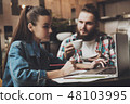 Beautiful girl working behind a laptop in a cafe 48103995