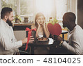 Two men congratulate young beautiful woman 48104025