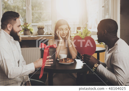 Two men congratulate young beautiful woman Two men congratulate young beautiful woman 48104025