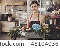 Portrait of beautiful girl florist in flower shop 48104036