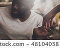 Sad man with a wedding ring in his hand 48104038