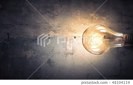 Light bulb on stone surface Light bulb on stone surface 48104119