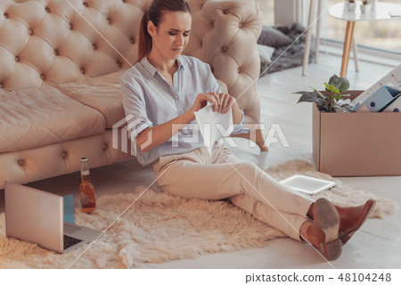 Displeased young woman tearing a letter from her boyfriend Displeased young woman tearing a letter from her boyfriend 48104248