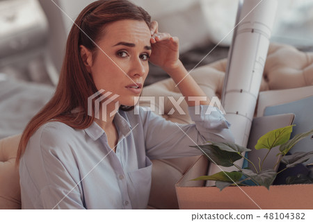 Close up of sad young woman touching her head 48104382
