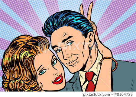 woman puts horns to man, hand gesture joke 48104723