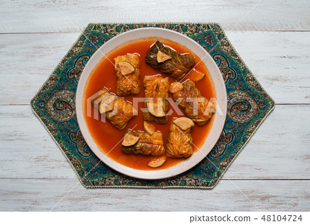 Indian cabbage rolls in curry sauce. Top view.  48104724