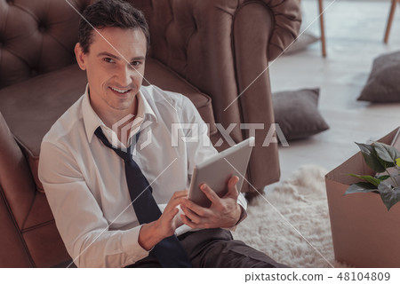 Waist up of cheerful man resting at home 48104809