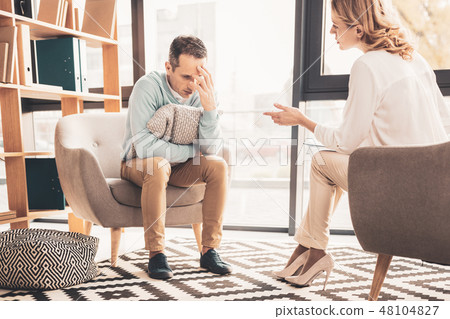 Curly-haired psychoanalyst speaking to her client Curly-haired psychoanalyst speaking to her client 48104827