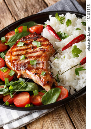 Grilled pork steak with rice garnish 48105128