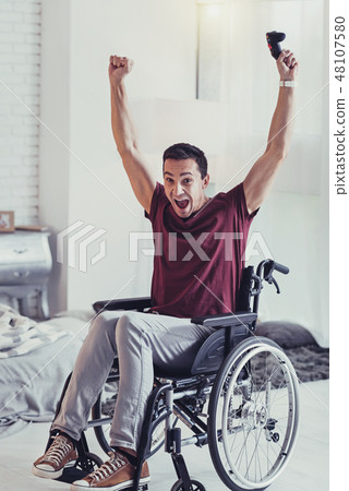 Happy disabled man winning the game Happy disabled man winning the game 48107580
