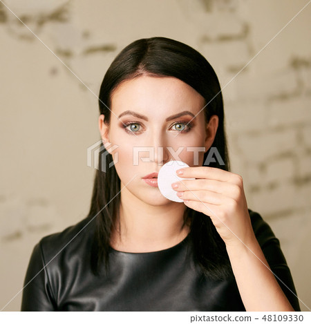 Home face care. Girl remove makeup. Woman hand 48109330