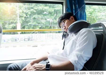 Tired man comfortably in bus and sleeping with cervical neck inf 48109529