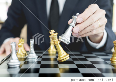 businessman playing  chess figure take a checkmate another king 48109561
