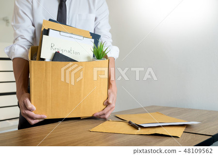 Businessmen are holding resignation document and packing persona 48109562