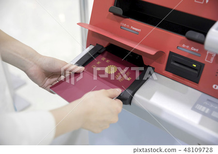 Female hand to use automatic check-in machine at airport 48109728