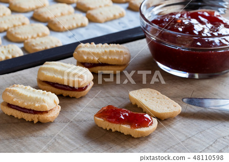 Filling Christmas cookies with jam Filling Christmas cookies with jam 48110598