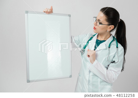 Portrait of woman wearing glasses in white robe with magnetic Board in hands isolated on white 48112258