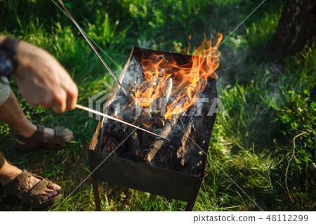 BBQ with wood on the green grass. View from above. 48112299